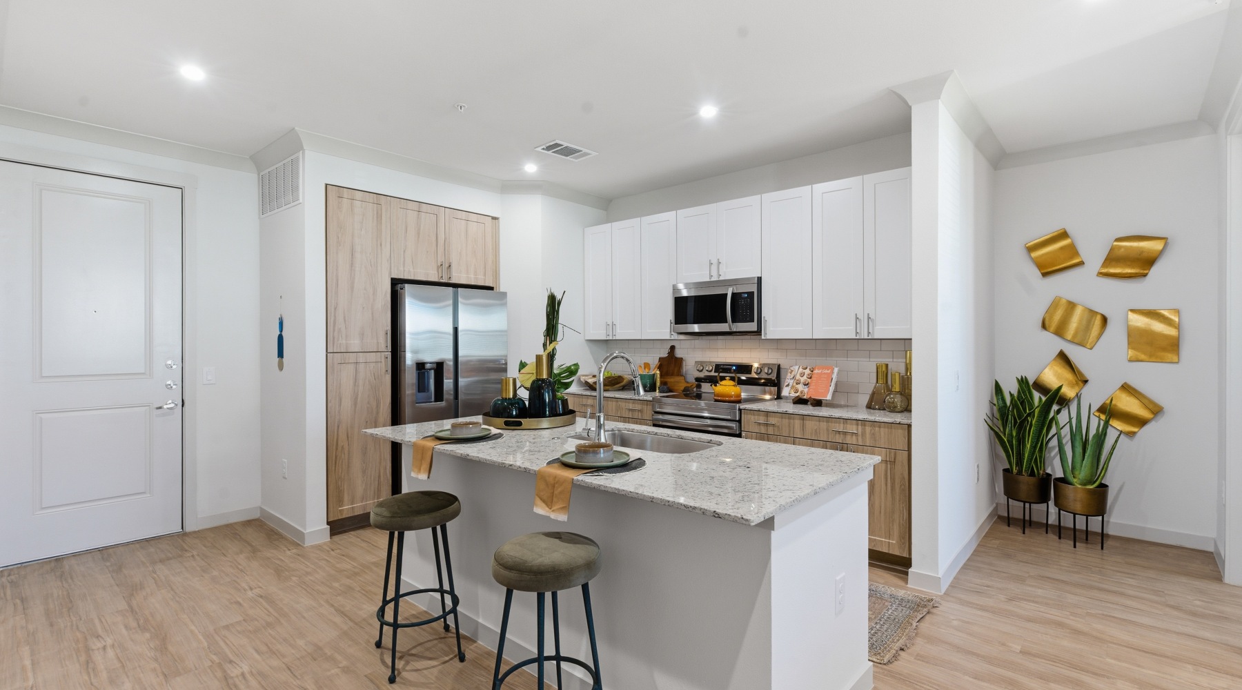 kitchen island with stools, cabinets, refrigerator
