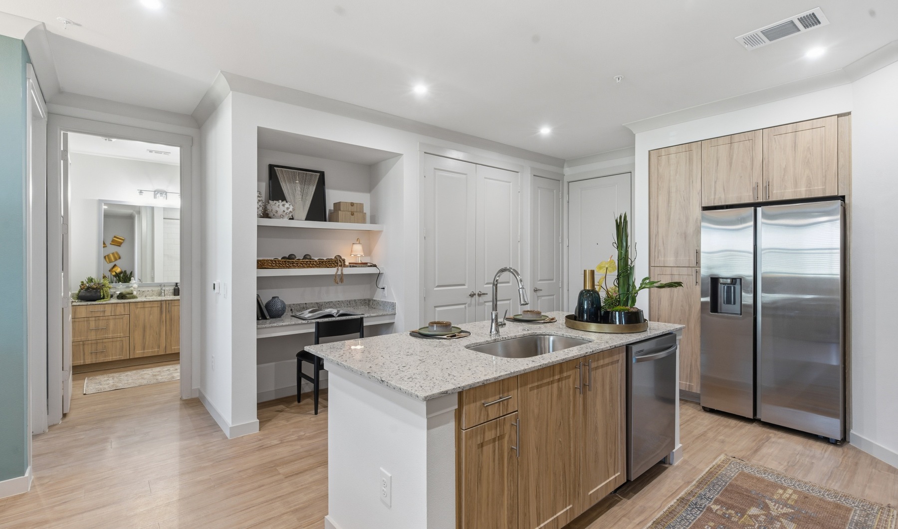 kitchen island with sink, cabinets and shelves